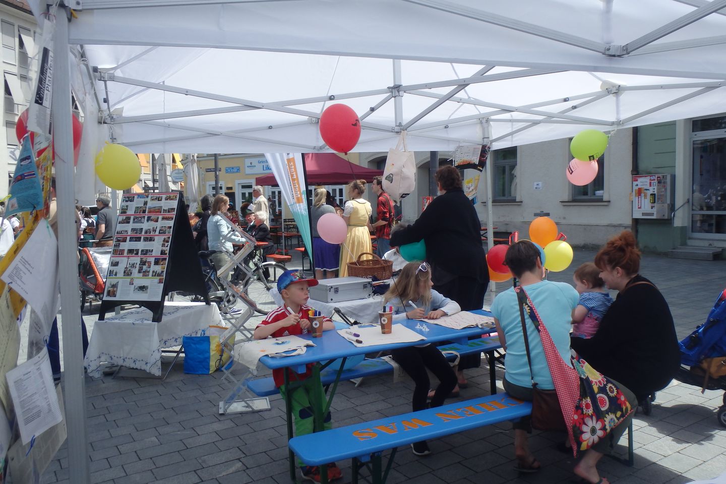 Kinder sitzen an Tischen und malen